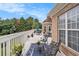 View of the spacious deck, with seating, overlooking a green backyard and blue sky at 127 Courts Of Hampton, Hampton, GA 30228