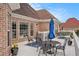 Back deck with outdoor seating, brick exterior, and covered patio space at 127 Courts Of Hampton, Hampton, GA 30228