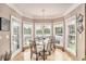 Dining area boasts large windows offering a view of the yard, and a modern light fixture at 127 Courts Of Hampton, Hampton, GA 30228