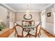 Elegant dining room boasts a crystal chandelier, hardwood floors, and ample seating for gatherings at 127 Courts Of Hampton, Hampton, GA 30228