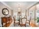 Formal dining room featuring a crystal chandelier, hardwood floors, and elegant furnishings at 127 Courts Of Hampton, Hampton, GA 30228