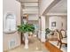 Elegant foyer with a grand staircase, arched doorways, and beautiful tile and hardwood floors at 127 Courts Of Hampton, Hampton, GA 30228