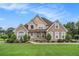 Charming two-story brick and stucco home with a manicured lawn and established landscaping at 127 Courts Of Hampton, Hampton, GA 30228