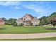 Beautiful brick home with a well-manicured lawn and mature landscaping in a suburban neighborhood at 127 Courts Of Hampton, Hampton, GA 30228