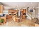 Bright kitchen features a central island, tile flooring, and custom wood cabinets at 127 Courts Of Hampton, Hampton, GA 30228