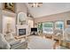 Living room features hardwood floors, a cozy fireplace, and access to the backyard at 127 Courts Of Hampton, Hampton, GA 30228