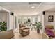 Bright living room featuring bay window, comfortable seating, and neutral carpet at 127 Courts Of Hampton, Hampton, GA 30228