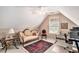 Loft area with beige walls, an antique sofa, a window and carpet flooring at 127 Courts Of Hampton, Hampton, GA 30228
