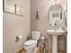 Cozy powder room featuring pedestal sink, oval mirror, and decorative elements at 127 Courts Of Hampton, Hampton, GA 30228