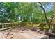 Back deck featuring a wooden railing and a view of the landscaped yard at 2120 Habersham Trce, Cumming, GA 30041