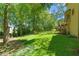 Expansive backyard with lush lawn, tall trees, and charming fence, perfect for outdoor living at 2120 Habersham Trce, Cumming, GA 30041