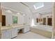 Bathroom with double sinks, a bathtub, skylight and neutral tile at 2120 Habersham Trce, Cumming, GA 30041