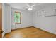 Bedroom featuring hardwood floors, a bright window, and hanging shelves at 2120 Habersham Trce, Cumming, GA 30041