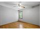 Bedroom features hardwood floors, a ceiling fan, and a bright window at 2120 Habersham Trce, Cumming, GA 30041