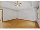 Bedroom with a tray ceiling, ceiling fan and gleaming hardwood floors at 2120 Habersham Trce, Cumming, GA 30041