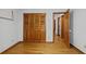 Bedroom featuring wood closet doors and hardwood floors at 2120 Habersham Trce, Cumming, GA 30041