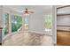 Bright breakfast nook featuring tile floors, large windows, and a ceiling fan with views of the surrounding landscape at 2120 Habersham Trce, Cumming, GA 30041