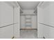 Walk-in closet with shelves, rods and neutral carpet at 2120 Habersham Trce, Cumming, GA 30041