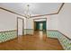 Bright dining room with hardwood floors, decorative wall paper, chandelier and open view into the Living Room at 2120 Habersham Trce, Cumming, GA 30041