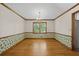 Charming dining room featuring hardwood floors, decorative wall paper, and chandelier lighting at 2120 Habersham Trce, Cumming, GA 30041