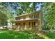 Charming two-story home with a welcoming front porch and manicured lawn at 2120 Habersham Trce, Cumming, GA 30041