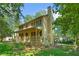 Side view of a charming two-story home with a porch and a lush, green yard and deck in back at 2120 Habersham Trce, Cumming, GA 30041