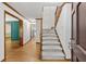 Inviting foyer with hardwood floors, staircase, and views into adjacent rooms with a view through to the kitchen at 2120 Habersham Trce, Cumming, GA 30041