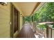 Close-up of the porch showcasing the wood flooring and view of the green lawn at 2120 Habersham Trce, Cumming, GA 30041