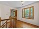 Hallway with wood floors and trim, plus a large window with natural light at 2120 Habersham Trce, Cumming, GA 30041