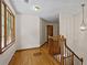Hallway with hardwood floors and a wooden staircase, plus a hanging light fixture at 2120 Habersham Trce, Cumming, GA 30041