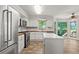 Bright kitchen featuring stainless steel appliances, white cabinets, and wood countertops at 2120 Habersham Trce, Cumming, GA 30041