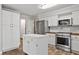 Bright kitchen with stainless steel appliances, island, and plenty of cabinet space at 2120 Habersham Trce, Cumming, GA 30041