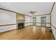 Cozy living room featuring hardwood floors, fireplace, and large windows for natural light at 2120 Habersham Trce, Cumming, GA 30041