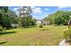 Expansive backyard showcasing a lush green lawn, mature trees, and the rear exterior of the home at 2675 Springside Ct, Douglasville, GA 30135