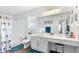 Well-lit bathroom with a sleek vanity, toilet, and shower/tub combo with blue patterned curtain at 2675 Springside Ct, Douglasville, GA 30135
