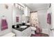 Well-lit bathroom featuring black granite countertops and a shower/tub combo with floral curtains at 2675 Springside Ct, Douglasville, GA 30135