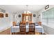 Traditional dining room with a large hutch, chandelier lighting, and a table set for Gathering dining at 2675 Springside Ct, Douglasville, GA 30135
