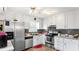 Efficient kitchen featuring stainless steel appliances, white cabinets, and a tiled backsplash at 2675 Springside Ct, Douglasville, GA 30135