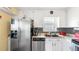 Modern kitchen featuring stainless steel appliances, white cabinets, and a tiled backsplash at 2675 Springside Ct, Douglasville, GA 30135