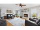 Comfortable living room with a white fireplace, hardwood floors, ceiling fan, and modern decor at 2675 Springside Ct, Douglasville, GA 30135