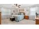 Spacious main bedroom with neutral carpet, ceiling fan, and natural light filtering through sheer curtains at 2675 Springside Ct, Douglasville, GA 30135