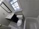 Upstairs bathroom featuring sleek black vanity, and classic white tile flooring at 3773 Summer Rose Dr, Atlanta, GA 30341