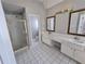 A bright bathroom featuring double vanity, glass enclosed shower and tile flooring at 3773 Summer Rose Dr, Atlanta, GA 30341
