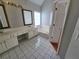 Bright bathroom featuring double vanity, tile flooring, and a separate tub at 3773 Summer Rose Dr, Atlanta, GA 30341