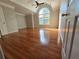 Large, sunlit bedroom featuring hardwood floors, neutral paint, and an arched window at 3773 Summer Rose Dr, Atlanta, GA 30341