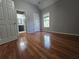 Bedroom featuring hardwood floors, neutral paint, and ensuite bathroom access at 3773 Summer Rose Dr, Atlanta, GA 30341
