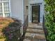 Inviting front entrance with stone steps, decorative railing, and lush landscaping at 3773 Summer Rose Dr, Atlanta, GA 30341