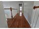 Hallway featuring hardwood floors and white railing leading to bedrooms at 3773 Summer Rose Dr, Atlanta, GA 30341