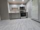 A kitchen with grey cabinets, quartz countertops, stainless steel appliances, and tile flooring at 3773 Summer Rose Dr, Atlanta, GA 30341