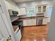 Well-equipped kitchen featuring modern stainless steel appliances, wood floors, and plentiful natural light at 3773 Summer Rose Dr, Atlanta, GA 30341
